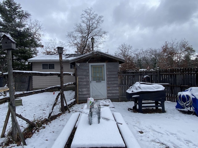 4038 W Brookview Dr, Prescott, MI 48756 - snow covered house with a storage unit