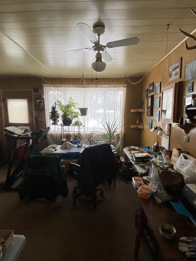 4038 W Brookview Dr, Prescott, MI 48756 - dining area featuring wooden walls, a ceiling fan, and carpet