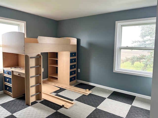 unfurnished bedroom with multiple windows