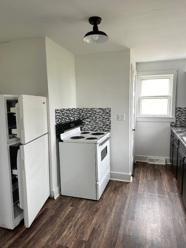 kitchen with white appliances, dark hardwood / wood-style floors, and tasteful backsplash