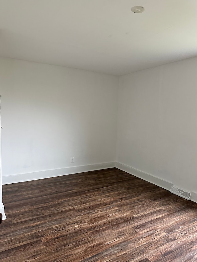 spare room with dark hardwood / wood-style floors