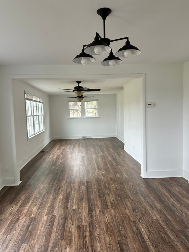 unfurnished room featuring ceiling fan and dark wood-type flooring