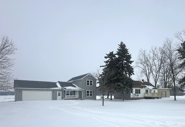 view of front of property with a deck and a garage