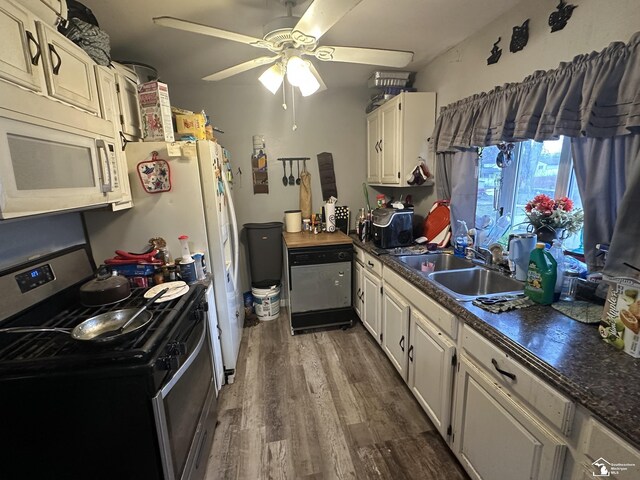 kitchen featuring white cabinetry, sink, ceiling fan, dark hardwood / wood-style floors, and appliances with stainless steel finishes