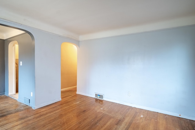 empty room with hardwood / wood-style flooring