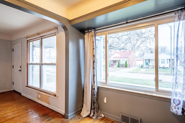 doorway to outside with plenty of natural light and hardwood / wood-style flooring