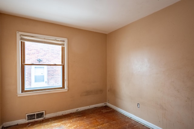 unfurnished room with hardwood / wood-style flooring