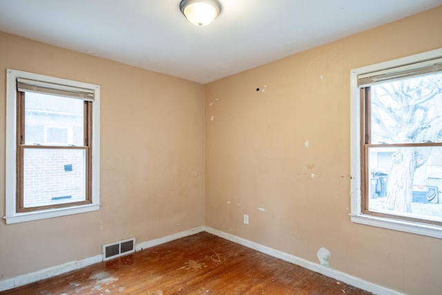 empty room with hardwood / wood-style flooring