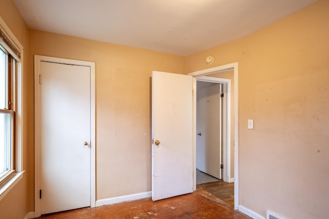 unfurnished bedroom with multiple windows