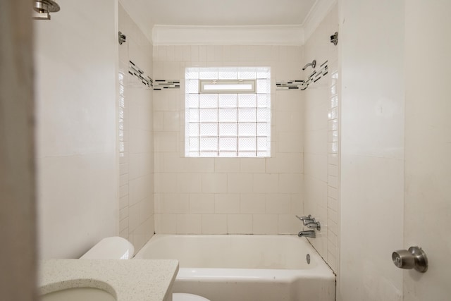 full bathroom featuring vanity, tiled shower / bath combo, toilet, and ornamental molding