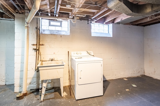 laundry room with a healthy amount of sunlight and washer / dryer