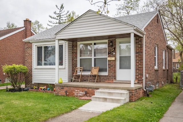 bungalow-style home featuring a porch and a front yard