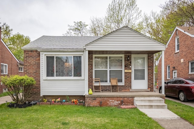 bungalow with a porch and a front lawn