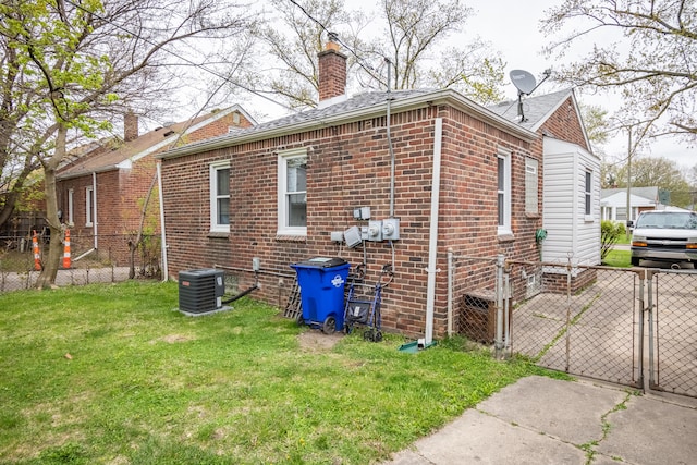 view of home's exterior with central air condition unit and a yard