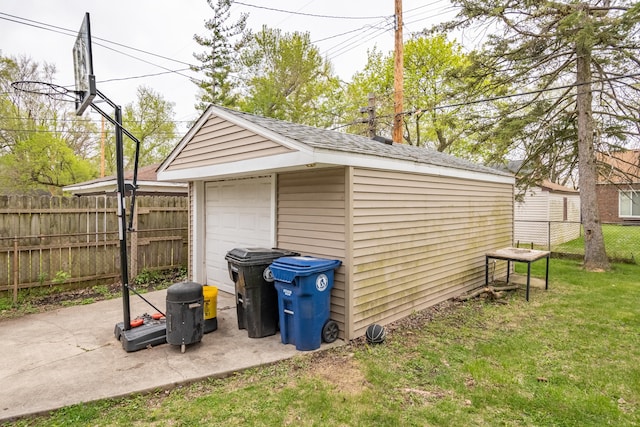 view of outdoor structure with a garage and a lawn