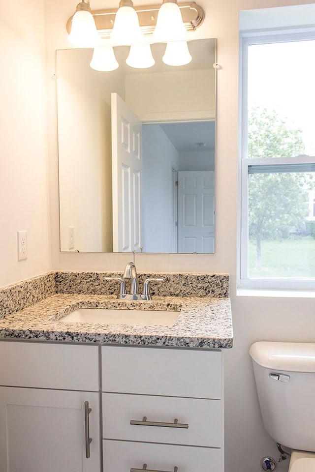 bathroom featuring toilet and vanity