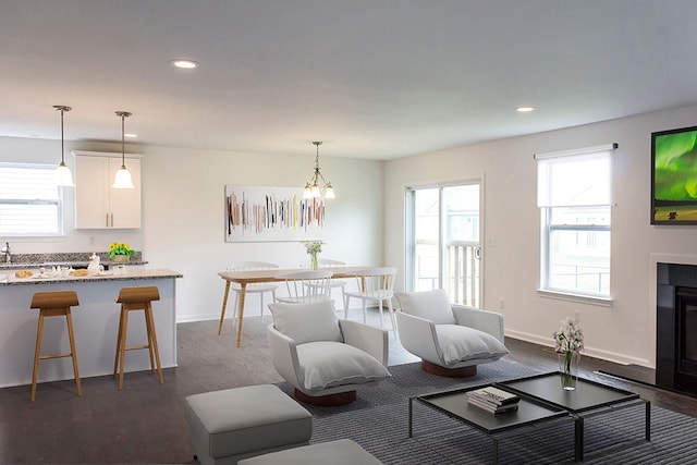 living room featuring dark hardwood / wood-style floors and a notable chandelier