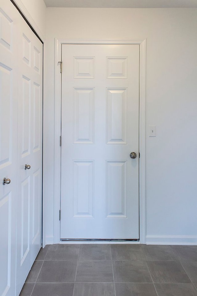 interior space featuring dark tile patterned flooring