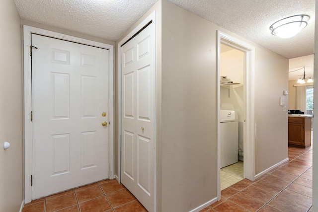 4980 Oak Hill Dr Unit 66, Waterford, MI 48329 - hall featuring washer / dryer, a textured ceiling, and tile patterned flooring