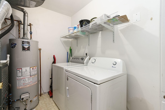 clothes washing area with gas water heater and washing machine and clothes dryer