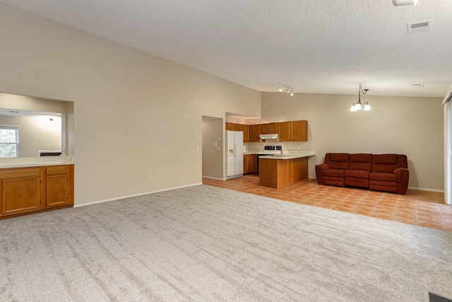 unfurnished living room featuring light colored carpet, lofted ceiling, a textured ceiling, and an inviting chandelier