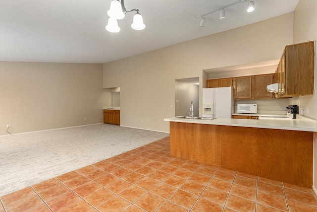 4980 Oak Hill Dr Unit 66, Waterford, MI 48329 - kitchen with white appliances, light colored carpet, brown cabinetry, light countertops, and vaulted ceiling