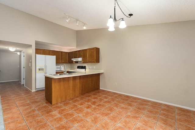 kitchen featuring kitchen peninsula, white refrigerator with ice dispenser, pendant lighting, an inviting chandelier, and light tile patterned flooring