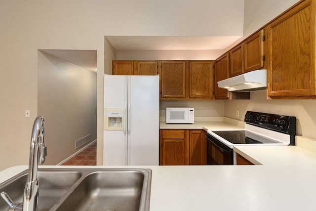 4980 Oak Hill Dr Unit 66, Waterford, MI 48329 - kitchen featuring white appliances, under cabinet range hood, brown cabinetry, and light countertops