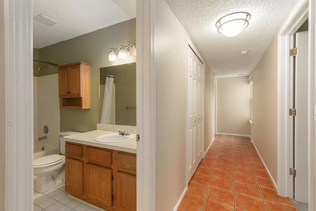 full bathroom featuring tile patterned floors, shower / tub combo, vanity, and a textured ceiling