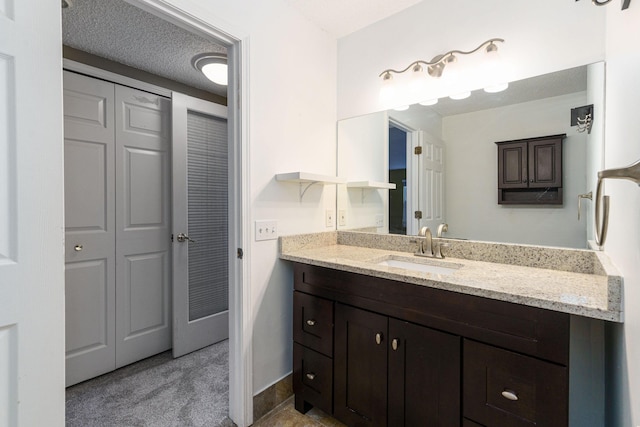 bathroom featuring vanity and a textured ceiling