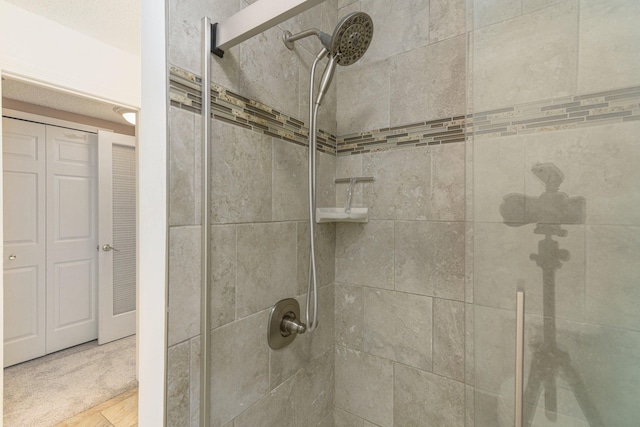 interior details featuring a tile shower