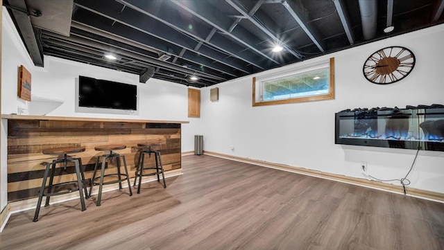 bar with hardwood / wood-style flooring