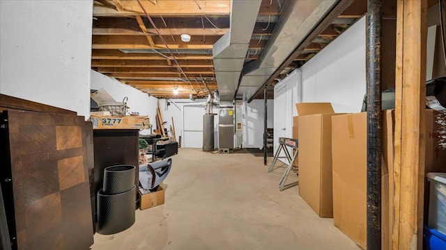 basement featuring a workshop area, water heater, and heating unit