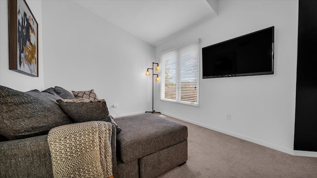 sitting room featuring carpet flooring and lofted ceiling