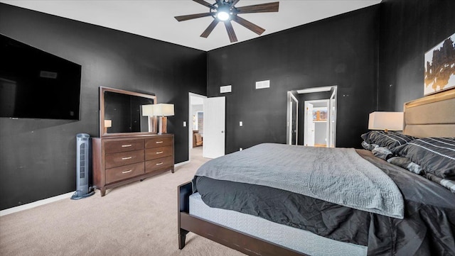 bedroom featuring light carpet and ceiling fan