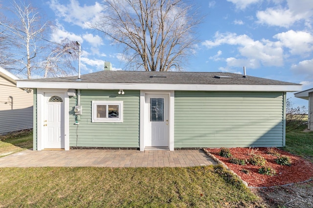 back of house featuring a lawn and a patio area