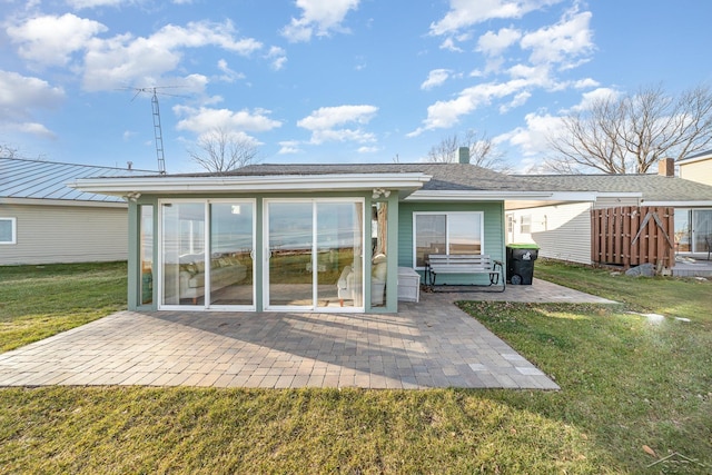 rear view of property with a lawn and a patio area