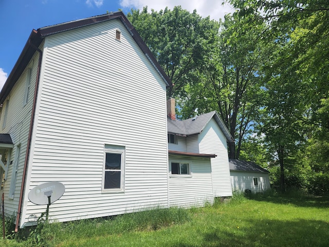 view of side of home featuring a lawn