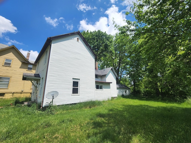 view of property exterior featuring a lawn