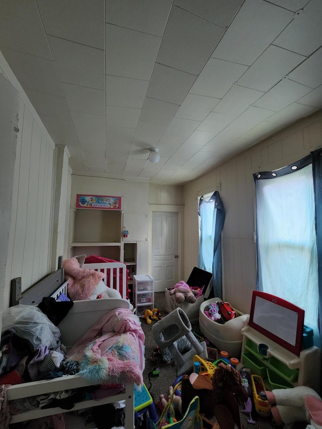 bedroom with wood walls