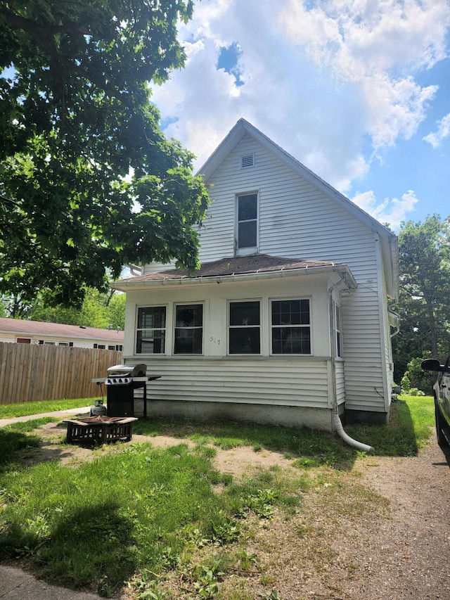 rear view of property with a yard