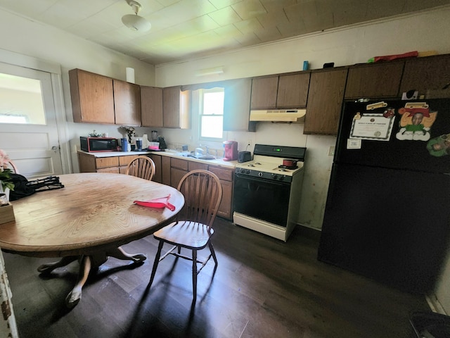 kitchen with ornamental molding, sink, dark wood-type flooring, and black appliances