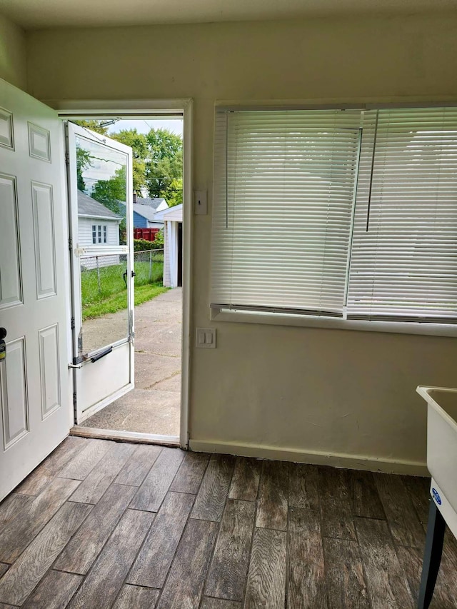 doorway to outside featuring dark wood-type flooring