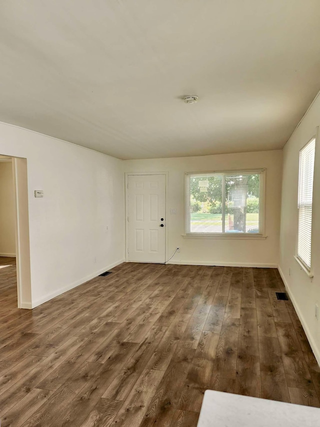 unfurnished room with dark hardwood / wood-style floors