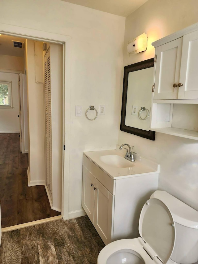 bathroom featuring hardwood / wood-style floors, vanity, and toilet