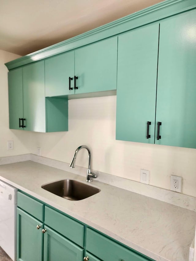 kitchen featuring dishwasher, green cabinetry, and sink