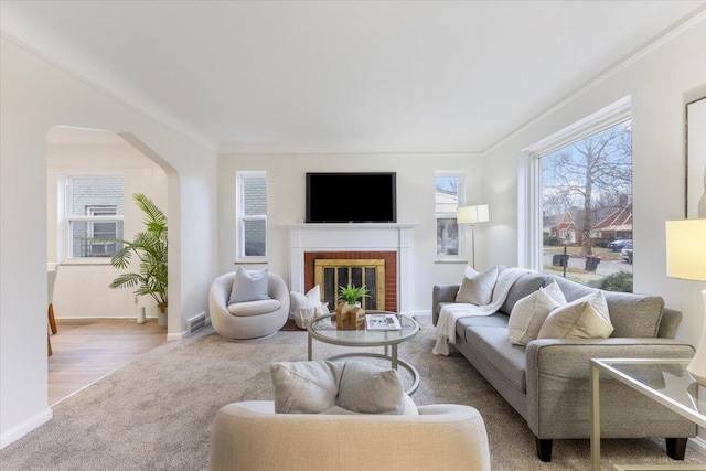11059 Lakepointe St, Detroit, MI 48224 - living room featuring crown molding, light hardwood / wood-style floors, and a brick fireplace