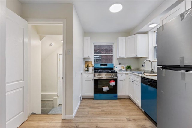 11059 Lakepointe St, Detroit, MI 48224 - kitchen with stainless steel appliances, white cabinetry, light wood-style floors, and light stone counters