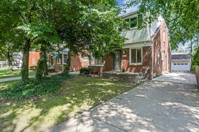 view of front of home with an outbuilding, a front lawn, and a garage