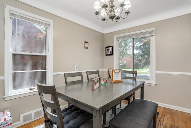 dining space featuring a chandelier, hardwood / wood-style floors, and plenty of natural light